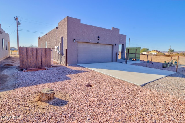 pueblo-style home with a garage