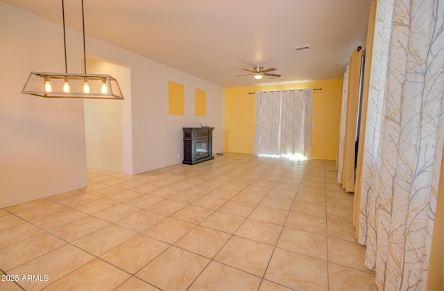 unfurnished living room featuring light tile patterned floors and ceiling fan