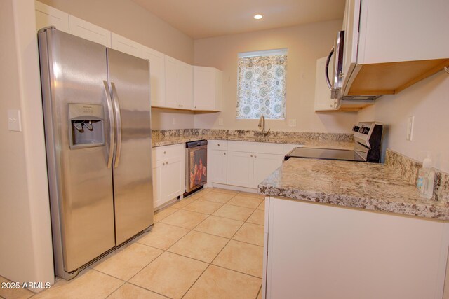 kitchen with stainless steel refrigerator with ice dispenser, beverage cooler, range, white cabinetry, and light tile patterned flooring