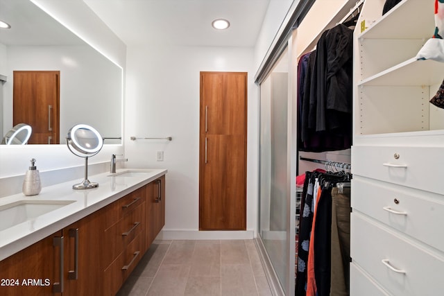 bathroom featuring vanity, an enclosed shower, and tile patterned floors