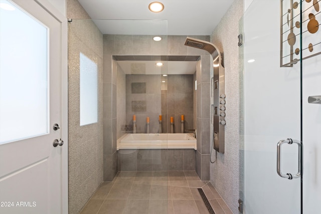 bathroom featuring tile walls, plus walk in shower, and tile patterned flooring