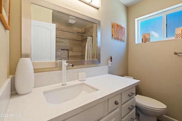 bathroom featuring vanity, toilet, and a shower with shower curtain