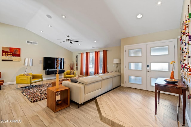 living room featuring french doors, vaulted ceiling, a wealth of natural light, and light hardwood / wood-style floors