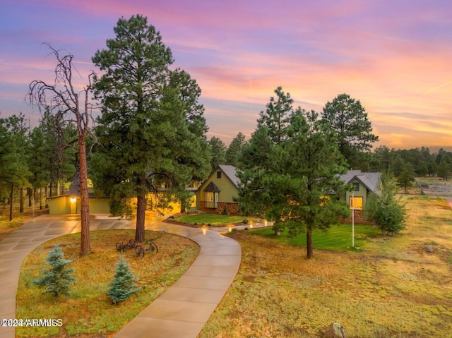 view of community with a garage and a yard