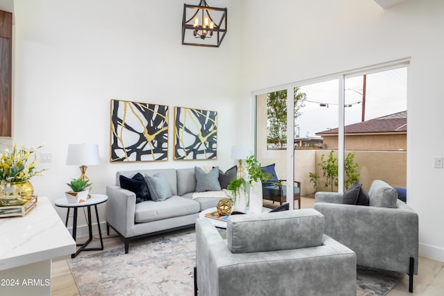 living room featuring a chandelier and light hardwood / wood-style floors