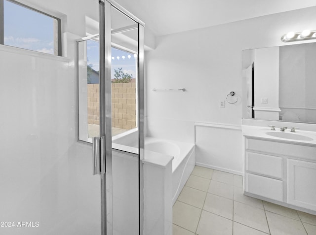 bathroom with tile patterned flooring, vanity, and separate shower and tub