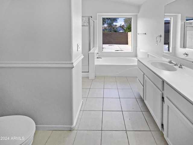 bathroom with tile patterned flooring, vanity, a bath, and toilet