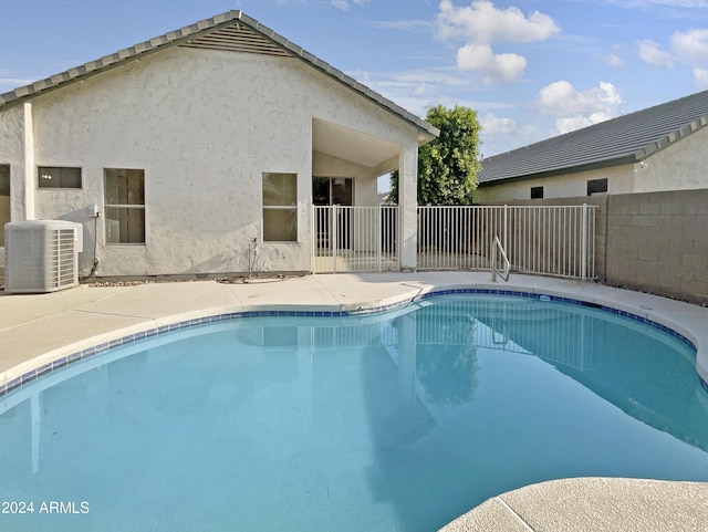 view of pool featuring central AC unit and a patio area