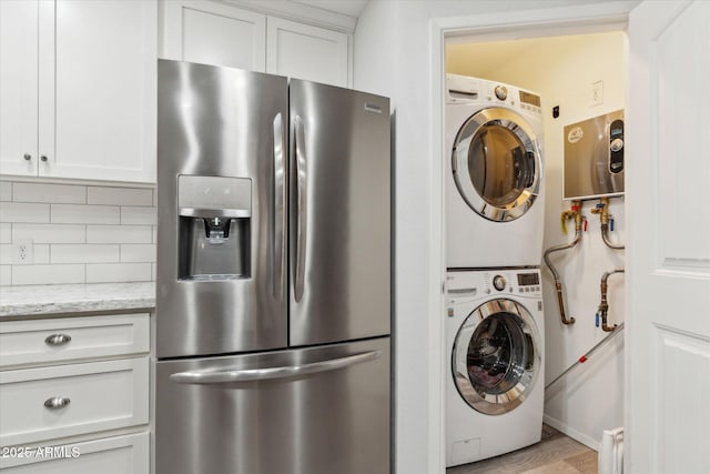 614 N Pioneer Cir, Mesa, AZ 85203 - washroom with stacked washing machine and dryer and light wood-style floors