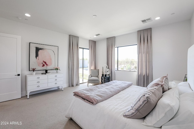 carpeted bedroom featuring recessed lighting and visible vents