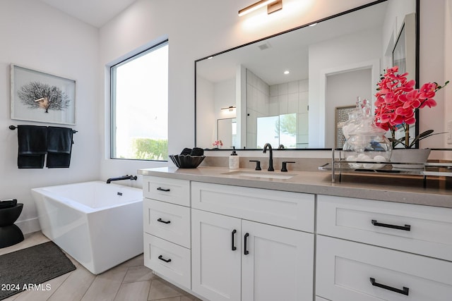 bathroom featuring visible vents, tiled shower, a freestanding bath, and vanity