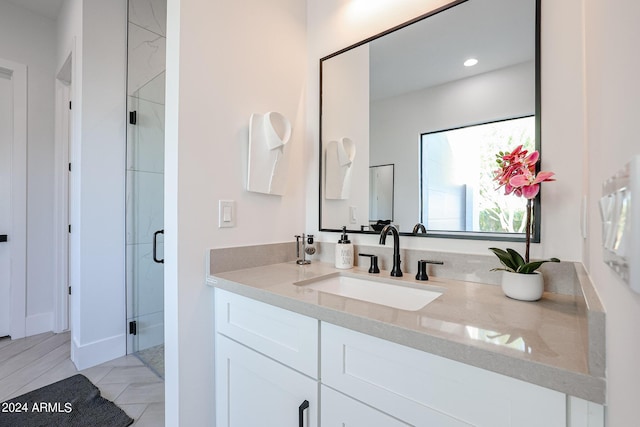 bathroom featuring a stall shower, vanity, and recessed lighting