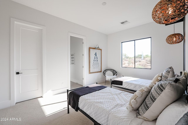 carpeted bedroom featuring visible vents and baseboards