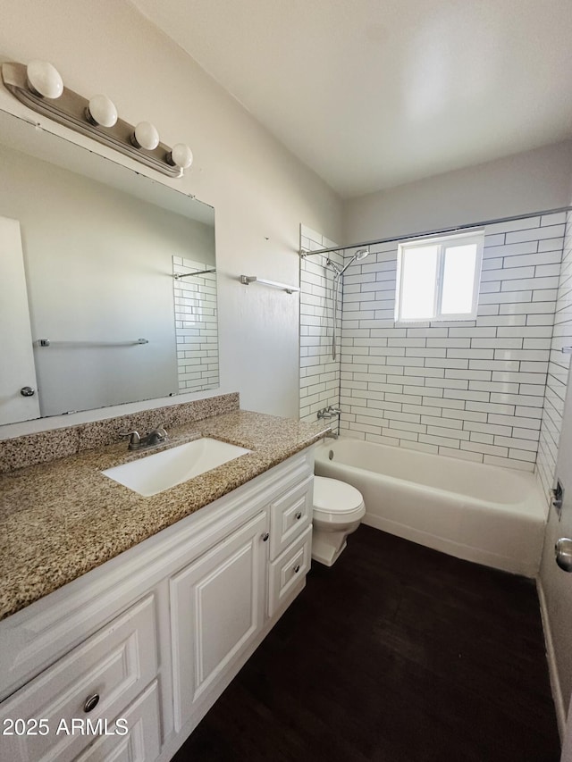 full bathroom featuring vanity, toilet, and tiled shower / bath combo