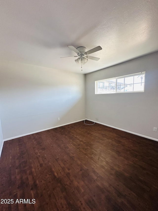 spare room featuring dark hardwood / wood-style floors and ceiling fan