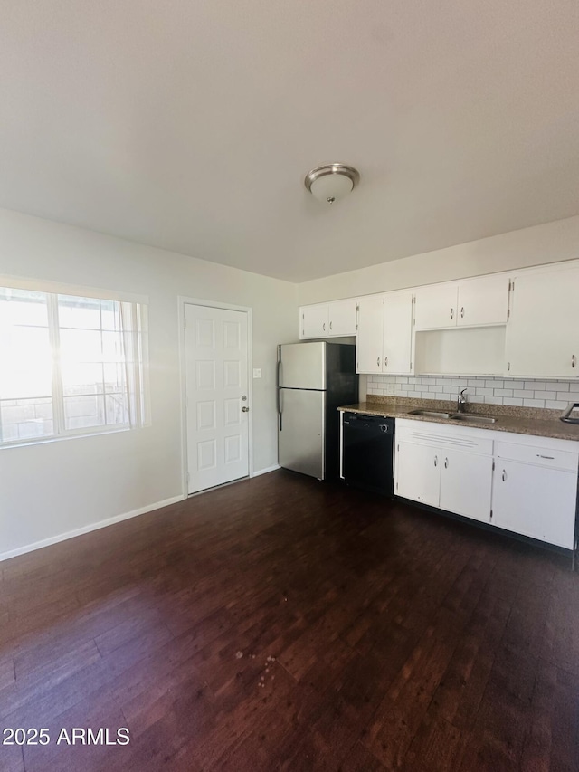 kitchen with sink, white cabinetry, stainless steel refrigerator, dark hardwood / wood-style floors, and dishwasher