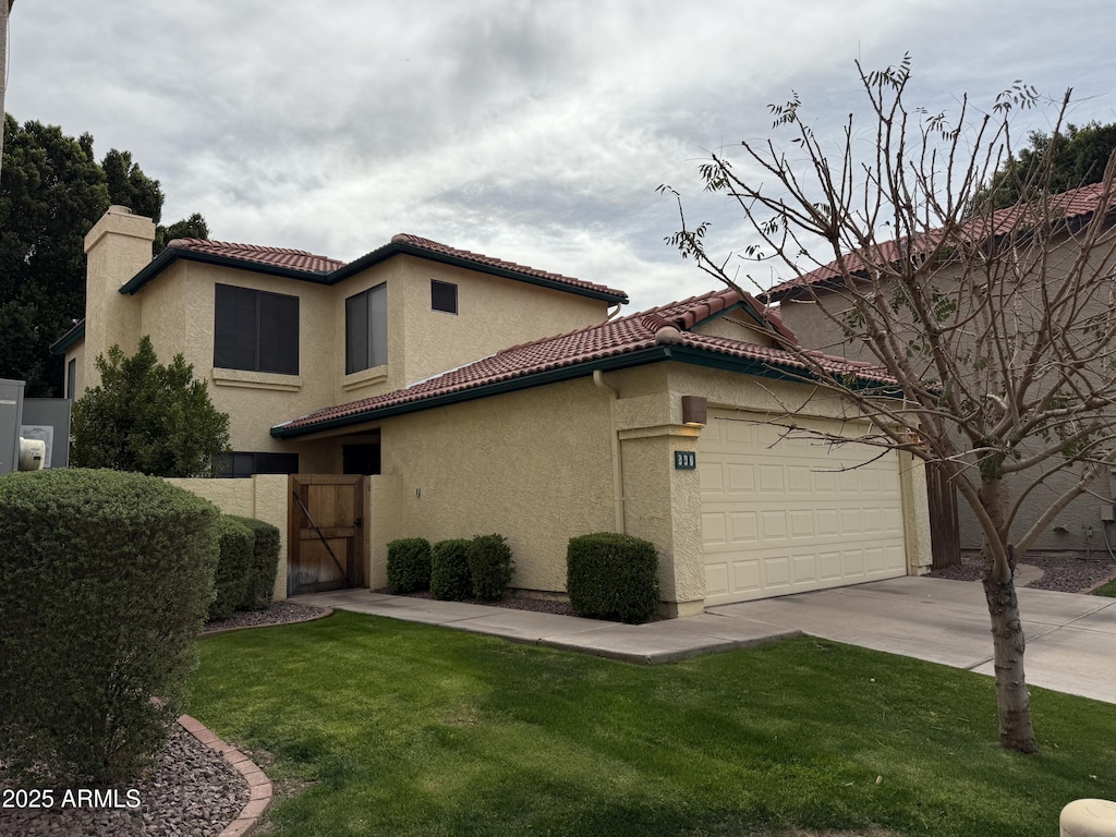 mediterranean / spanish-style house featuring a tile roof, driveway, and stucco siding