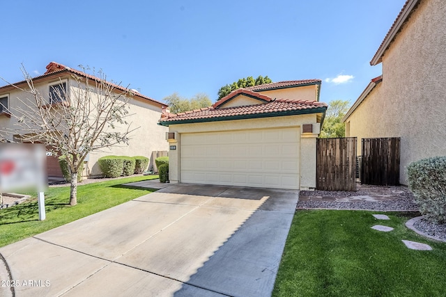 mediterranean / spanish home with a front yard, a tiled roof, concrete driveway, and stucco siding