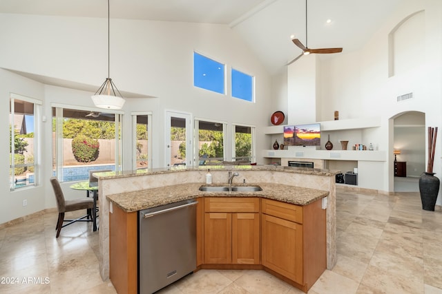 kitchen featuring pendant lighting, dishwasher, high vaulted ceiling, sink, and an island with sink