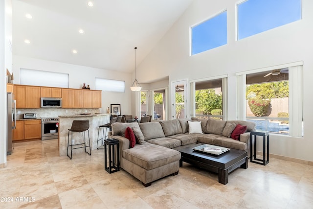 living room featuring high vaulted ceiling, a wealth of natural light, and ceiling fan