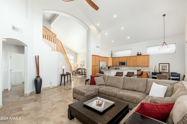 living room featuring high vaulted ceiling and ceiling fan