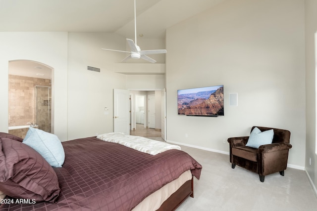 carpeted bedroom featuring connected bathroom, high vaulted ceiling, and ceiling fan