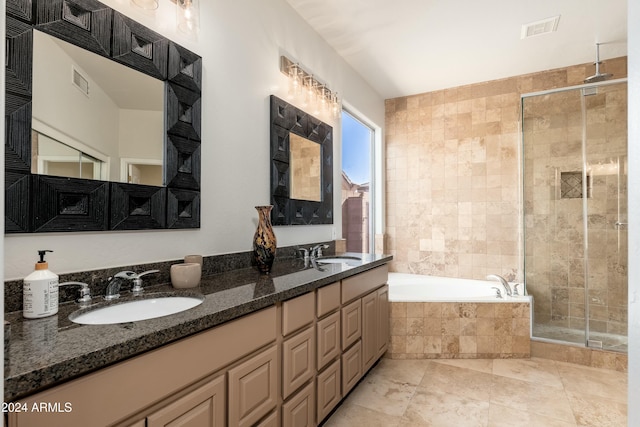 bathroom with vanity and independent shower and bath