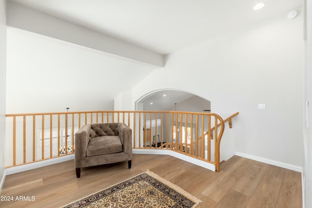 sitting room with beamed ceiling and light hardwood / wood-style floors