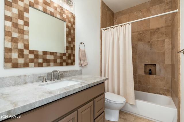 full bathroom with tile patterned floors, shower / tub combo with curtain, vanity, and toilet