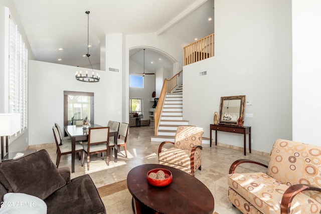 living room featuring beamed ceiling, ceiling fan with notable chandelier, and high vaulted ceiling