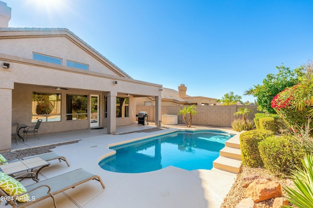 view of pool featuring ceiling fan, area for grilling, and a patio area