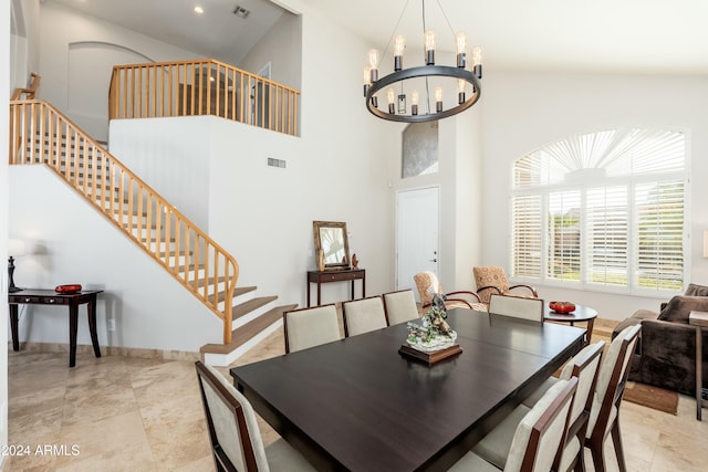 dining room with high vaulted ceiling and an inviting chandelier