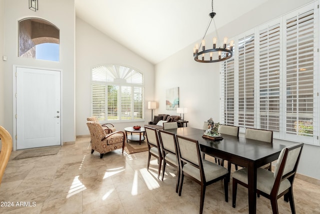 dining room with a chandelier, high vaulted ceiling, and a wealth of natural light