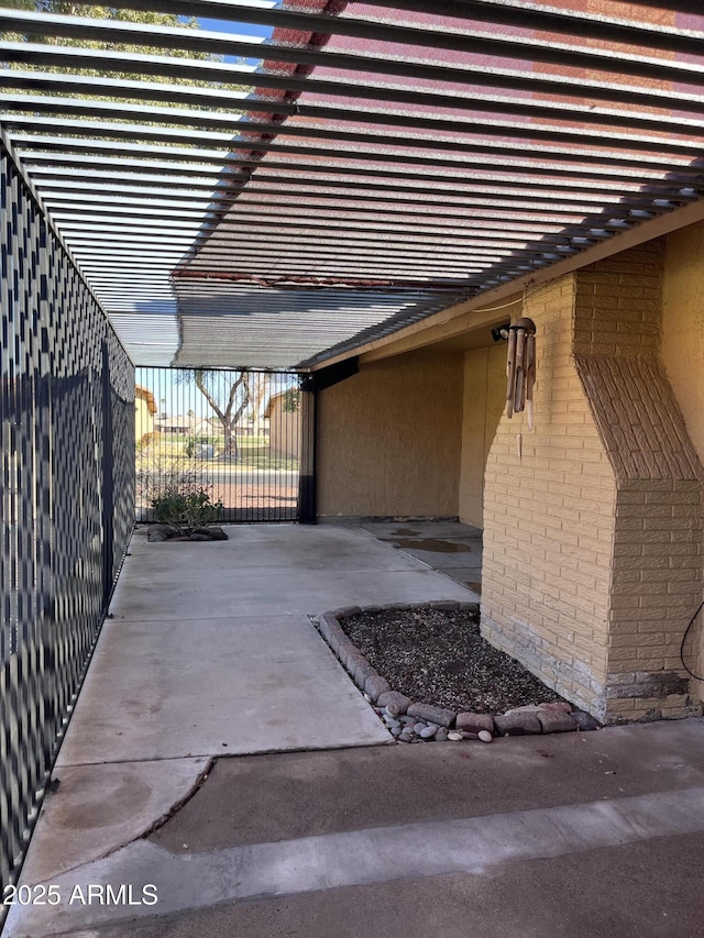 4916 E Hopi St, Phoenix, AZ 85044 - view of side of home featuring stucco siding, a patio area, fence, and brick siding