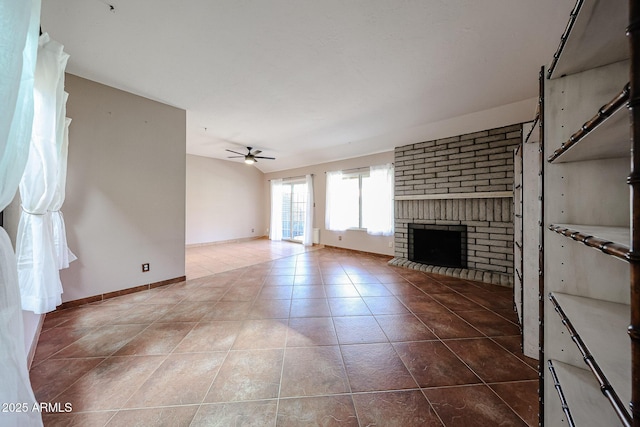 4916 E Hopi St, Phoenix, AZ 85044 - unfurnished living room with a brick fireplace, ceiling fan, baseboards, and tile patterned floors