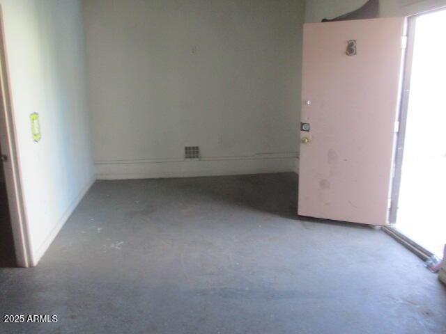 unfurnished room featuring concrete floors