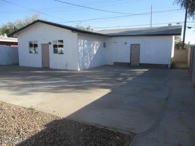 exterior space with fence and stucco siding