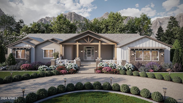 view of front facade with a mountain view and covered porch