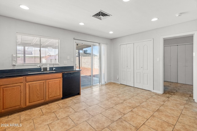 kitchen featuring dishwasher, light tile patterned flooring, and sink