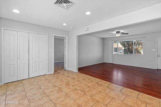 interior space with ceiling fan and light hardwood / wood-style flooring