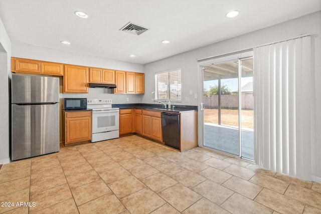 kitchen featuring sink, light tile patterned floors, and black appliances