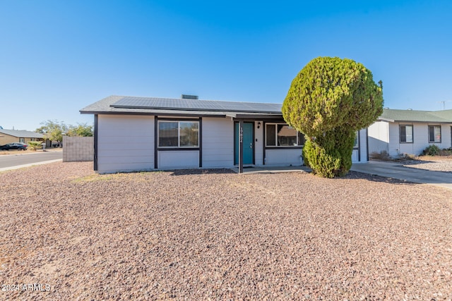 ranch-style house with solar panels