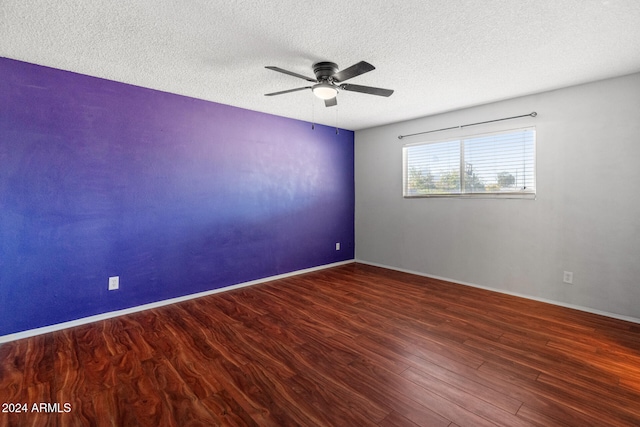 spare room with a textured ceiling, dark hardwood / wood-style flooring, and ceiling fan