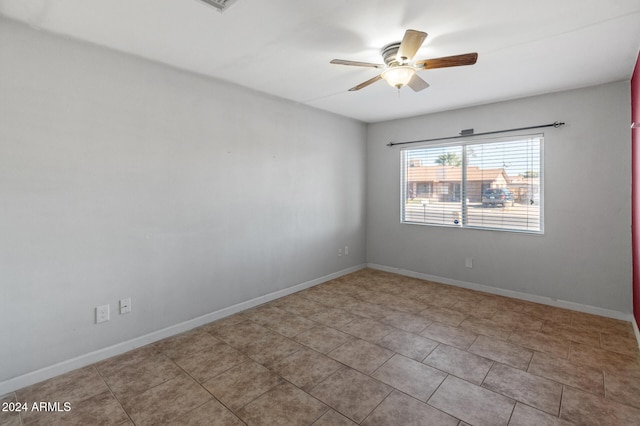 spare room featuring ceiling fan and light tile patterned flooring