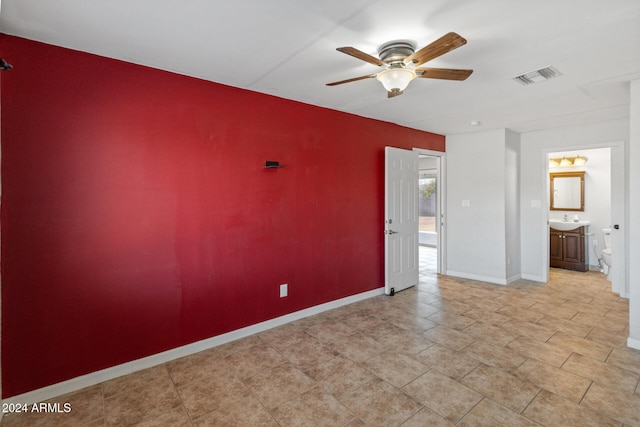 spare room featuring ceiling fan and sink