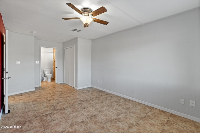 unfurnished bedroom with ceiling fan and ensuite bath