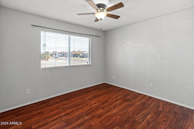 spare room featuring a textured ceiling, dark hardwood / wood-style flooring, and ceiling fan