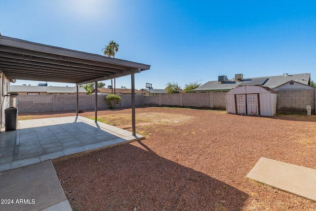 view of yard with a patio area and a storage unit