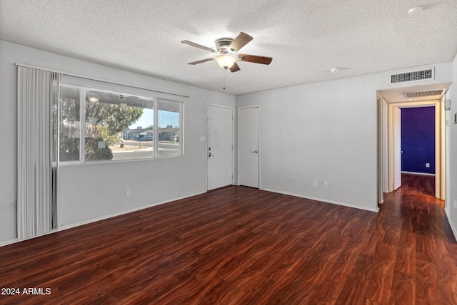 unfurnished room with a textured ceiling, dark hardwood / wood-style flooring, and ceiling fan