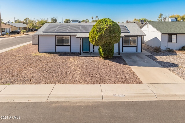 ranch-style house featuring solar panels